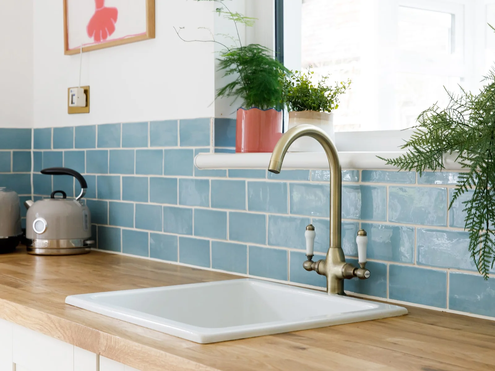 Pretty blue tiles and house plants line the kitchen.