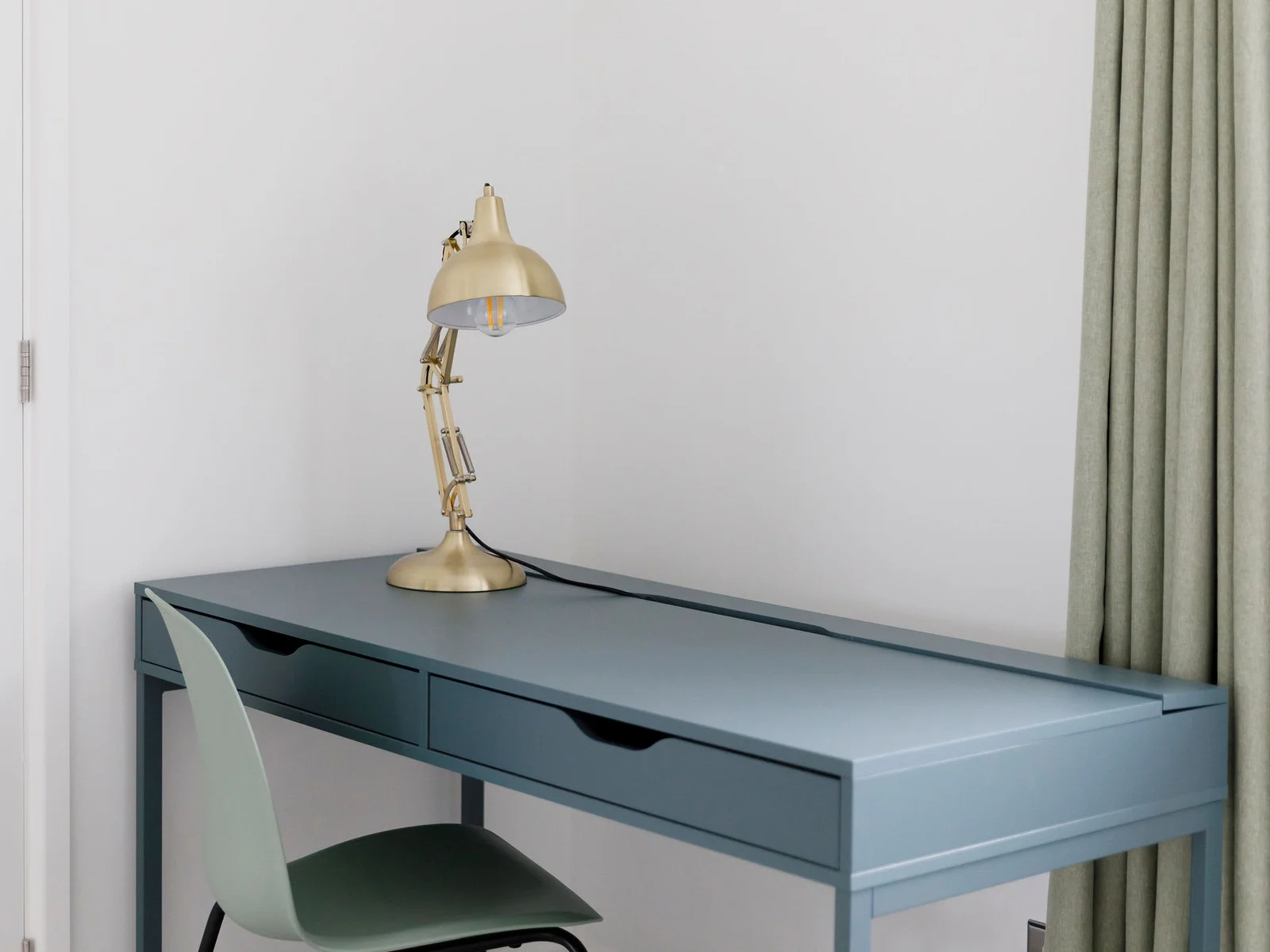 Elegant desk with a gold lamp, perfect for a home office setup