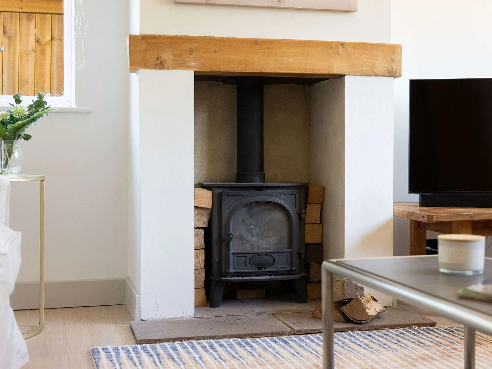 The cosy log burner adds warmth and character to the lounge, creating the perfect spot to relax and unwind on cooler days.