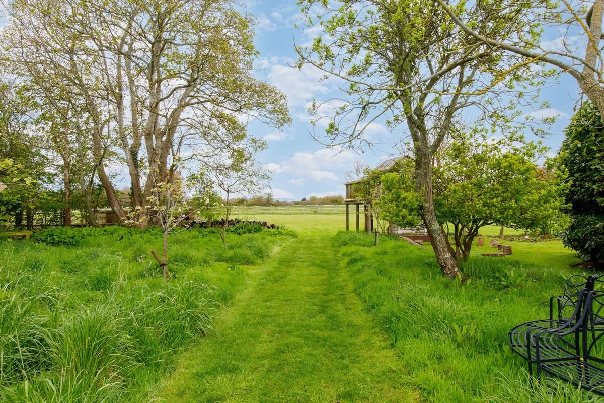 The home has extensive grounds, surrounded by lush countryside.