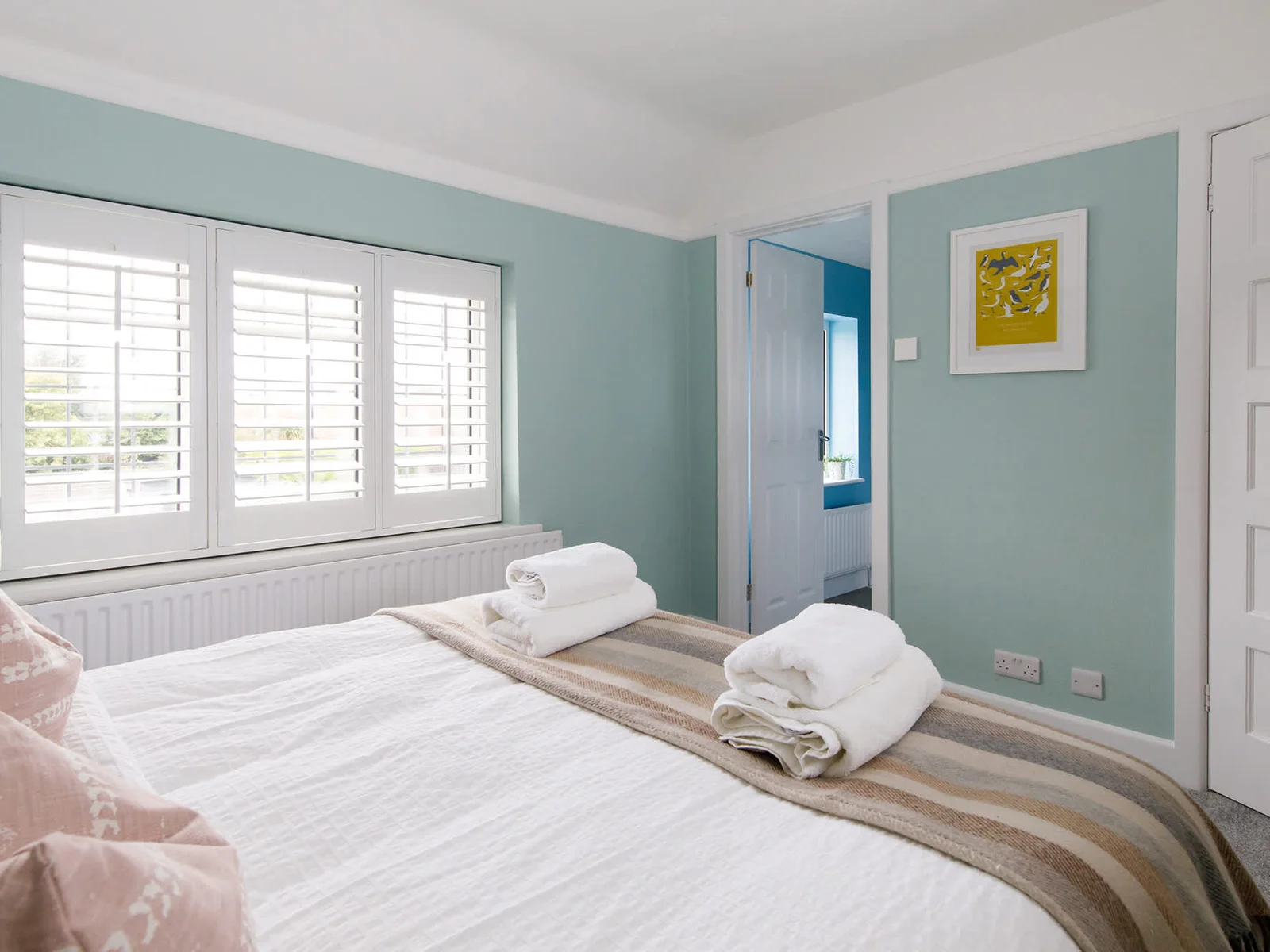The master bedroom has a luxurious king bed, with quality bedding, cushions and fresh linen.