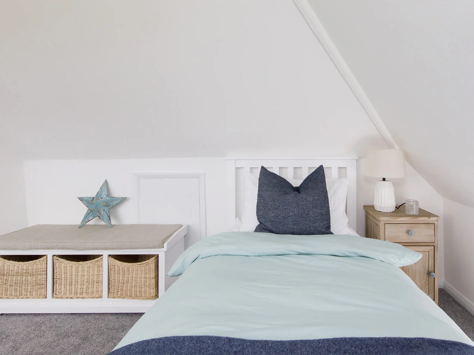 The loft room has a comfy single bed with partial sea views.