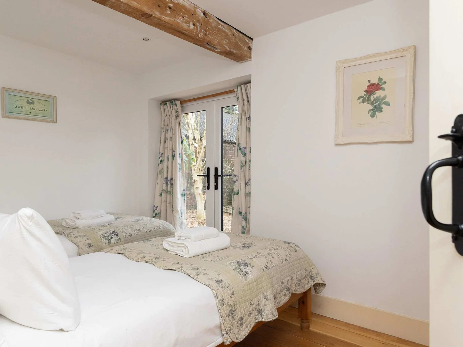 The downstairs twin with quality linen and pretty bed throws.