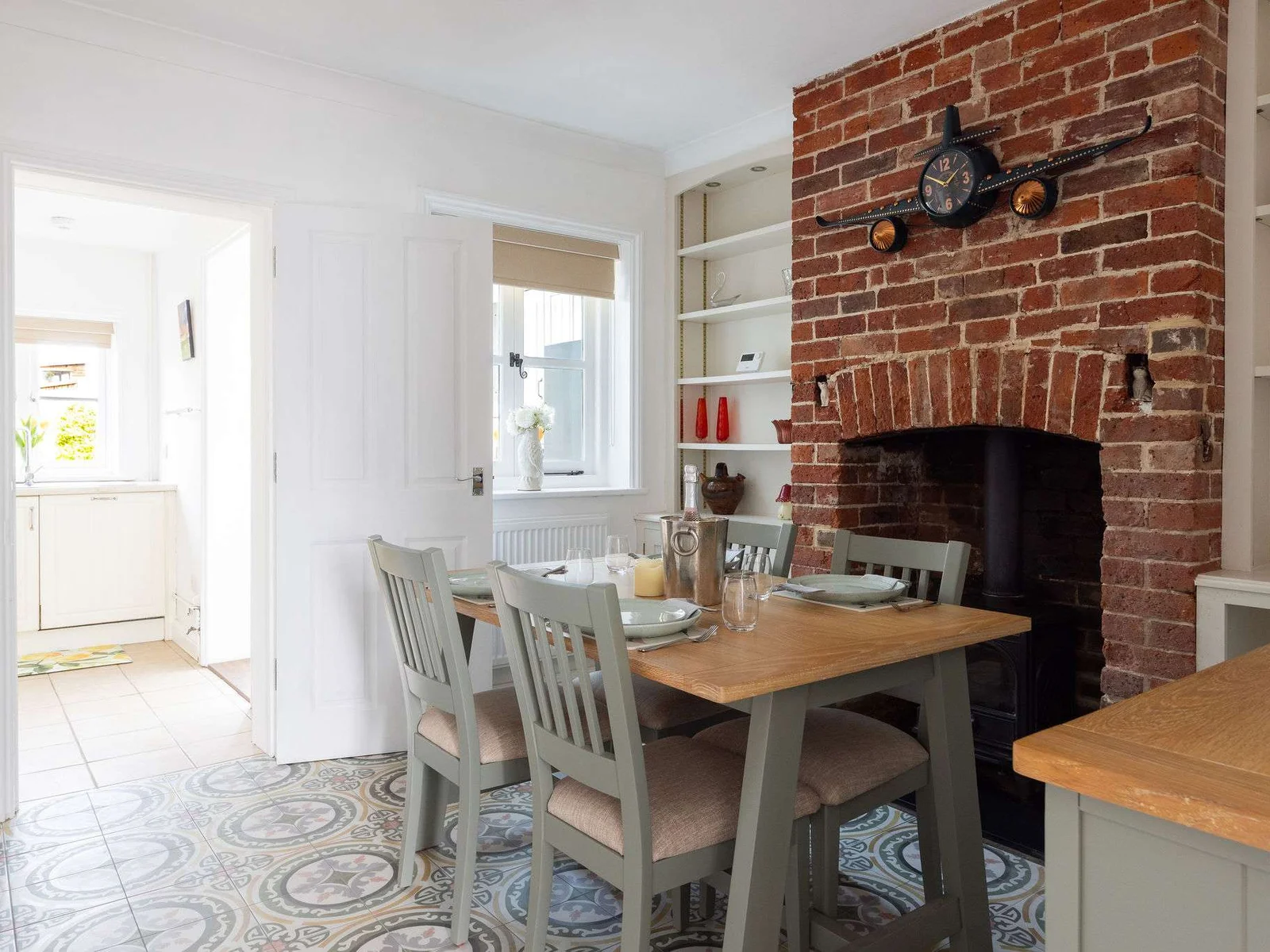 The dining area is located between the living room and kitchen.