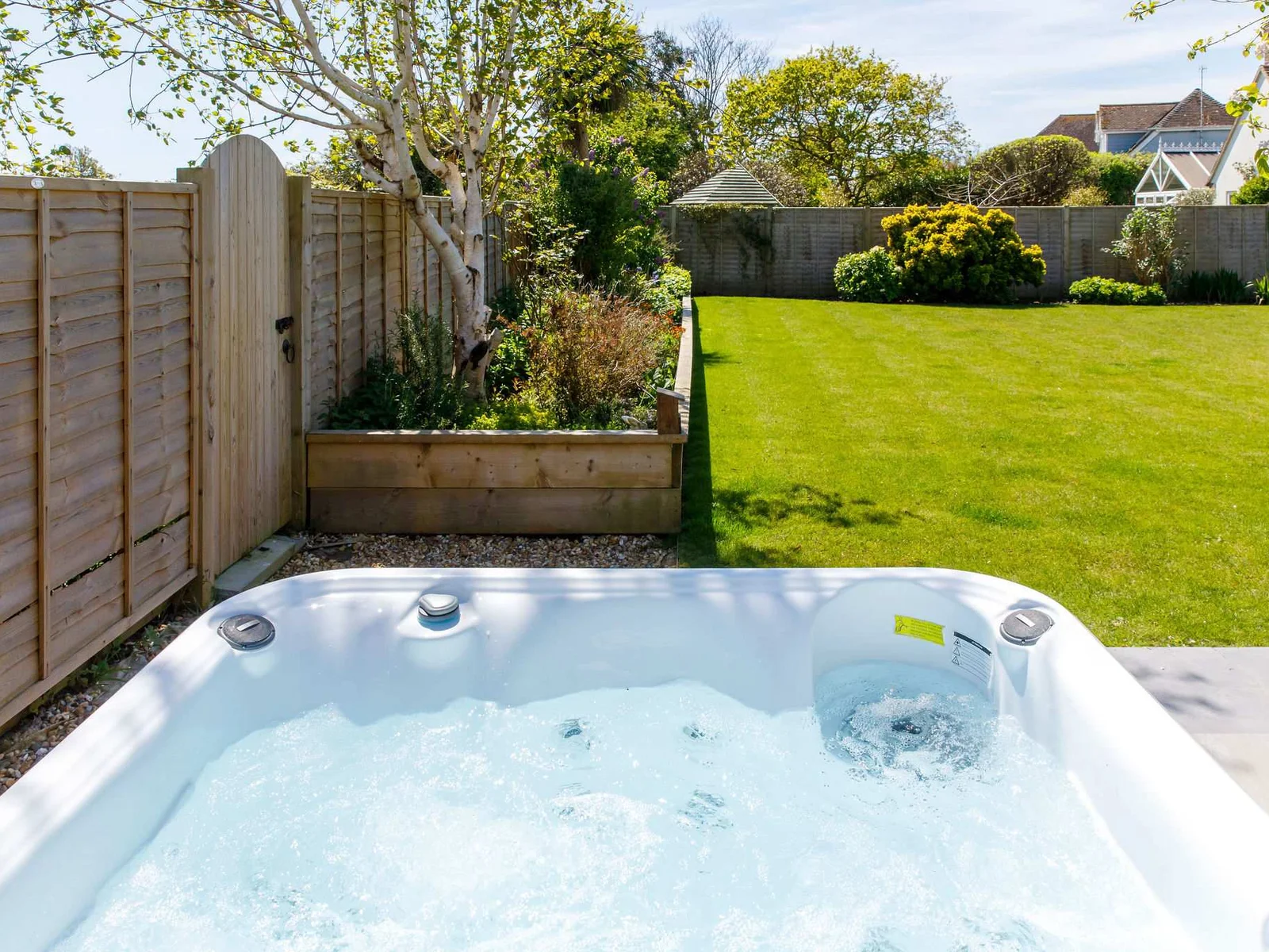 Expansive lawn area ideal for family games, picnics, or simply lounging under the sun.