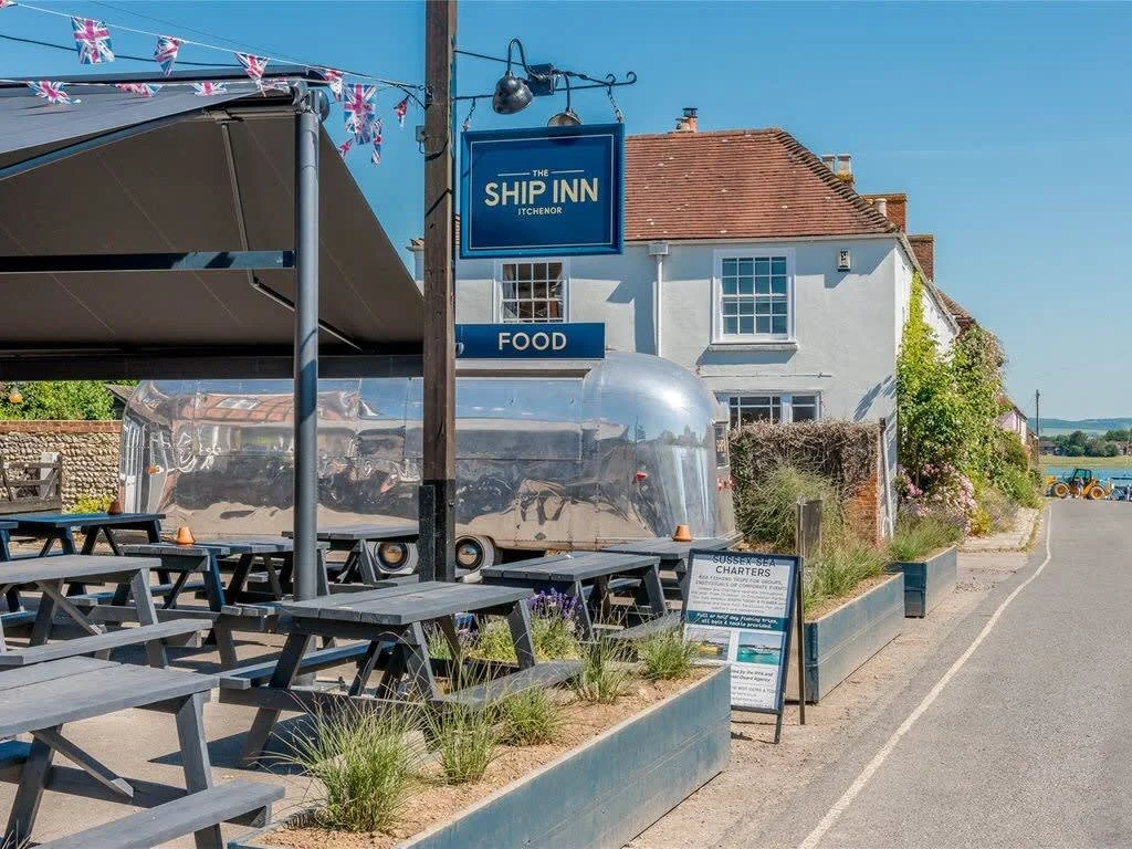 The Ship Inn in Itchenor is accessed via a ferry across the river. There's a TIKI bar behind the Pub, brilliant in the summer!