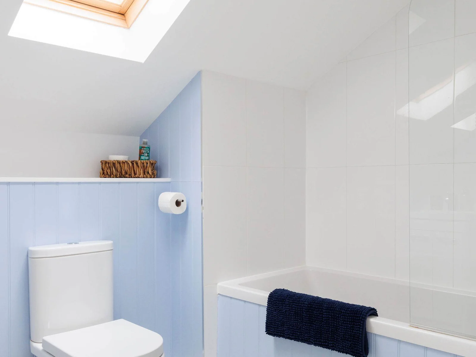 The upstairs bathroom is decorated in a soft blue.