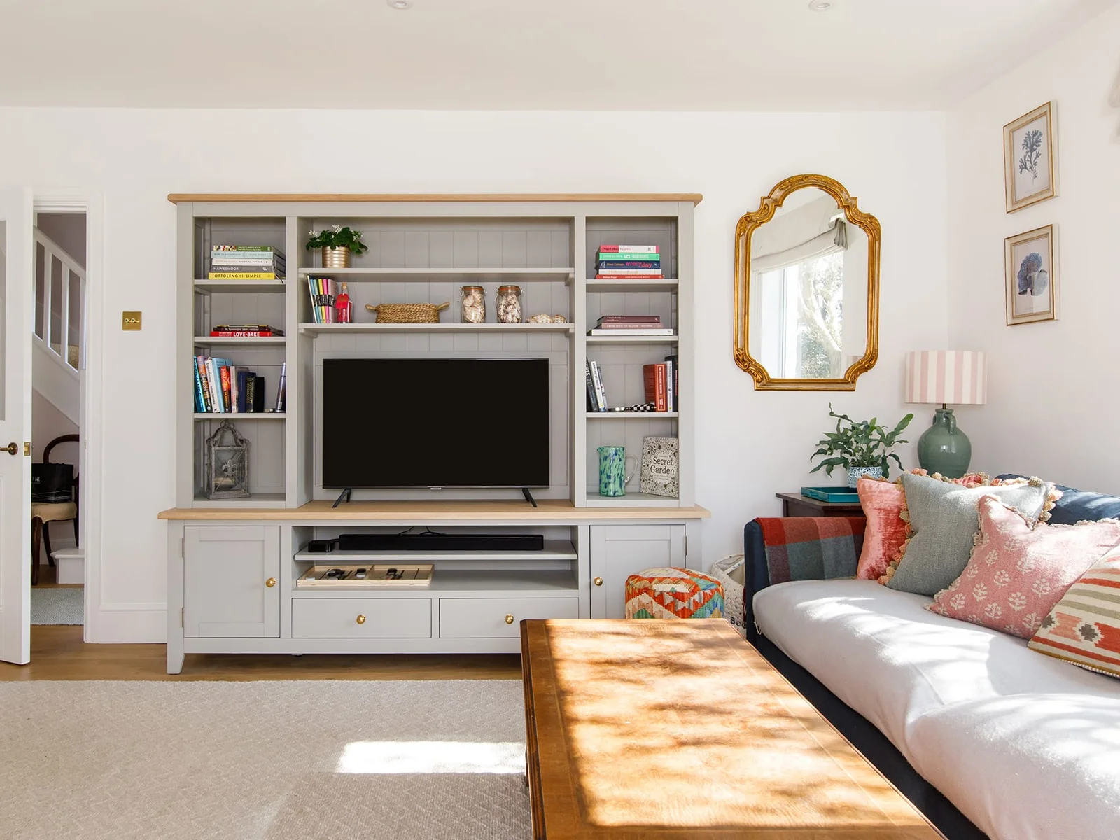 The cottage-style lounge has a log burner, comfy seating and homely touches.