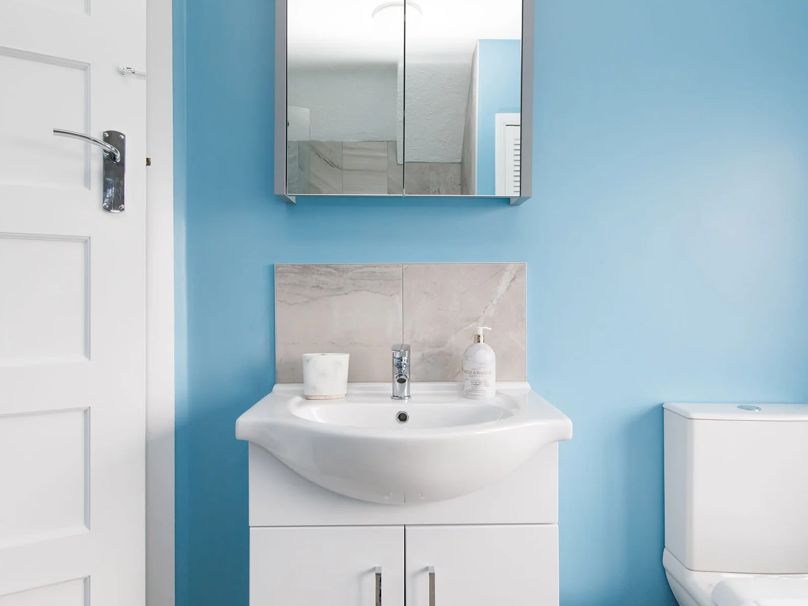 Freshen up after a day at the beach in the modern family bathroom.
