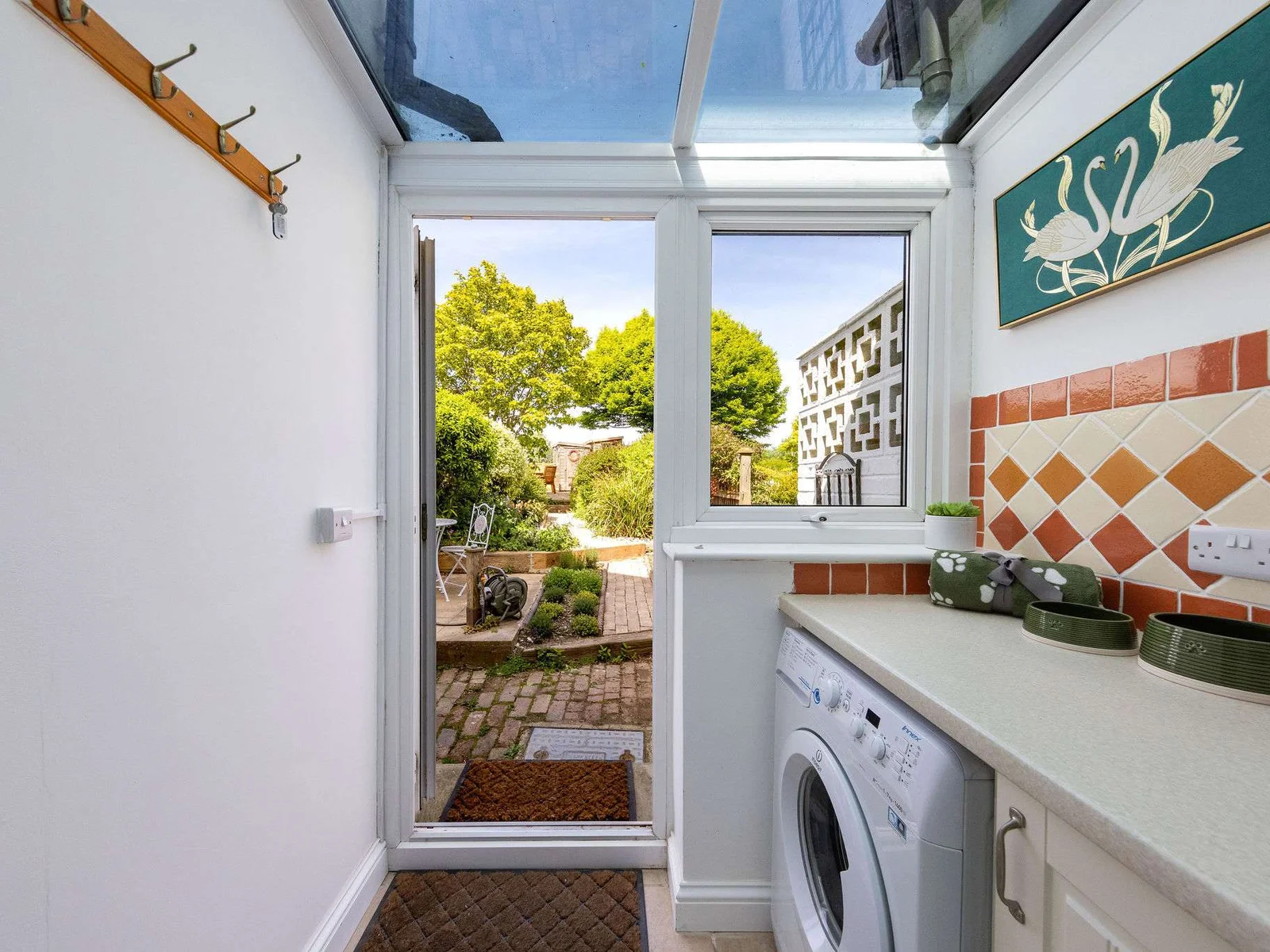 The cottage has a handy utility room with washing machine, countertop space and cabinets for storage.