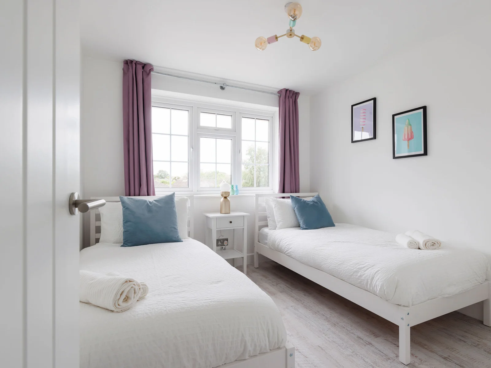 Twin bedroom with bright decor and comfortable bedding