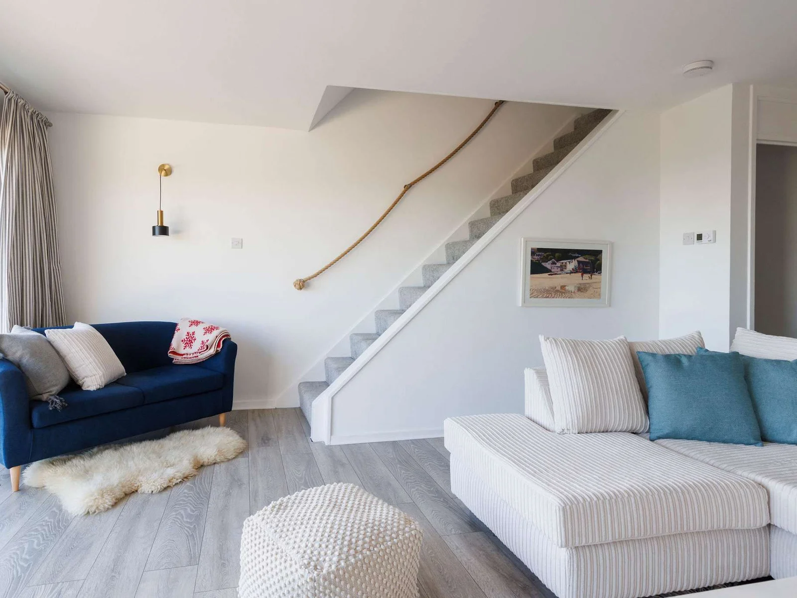Relax in style with a plush sofa and charming nautical accents