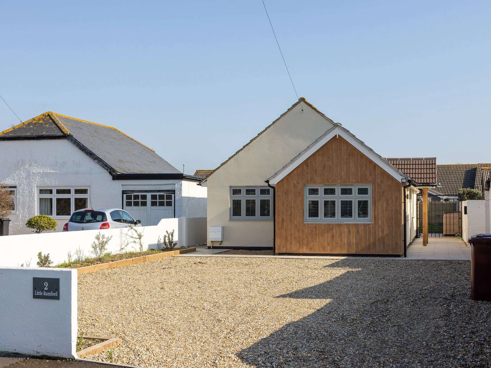 Stylish seaside home with private driveway parking and a welcoming, modern exterior.