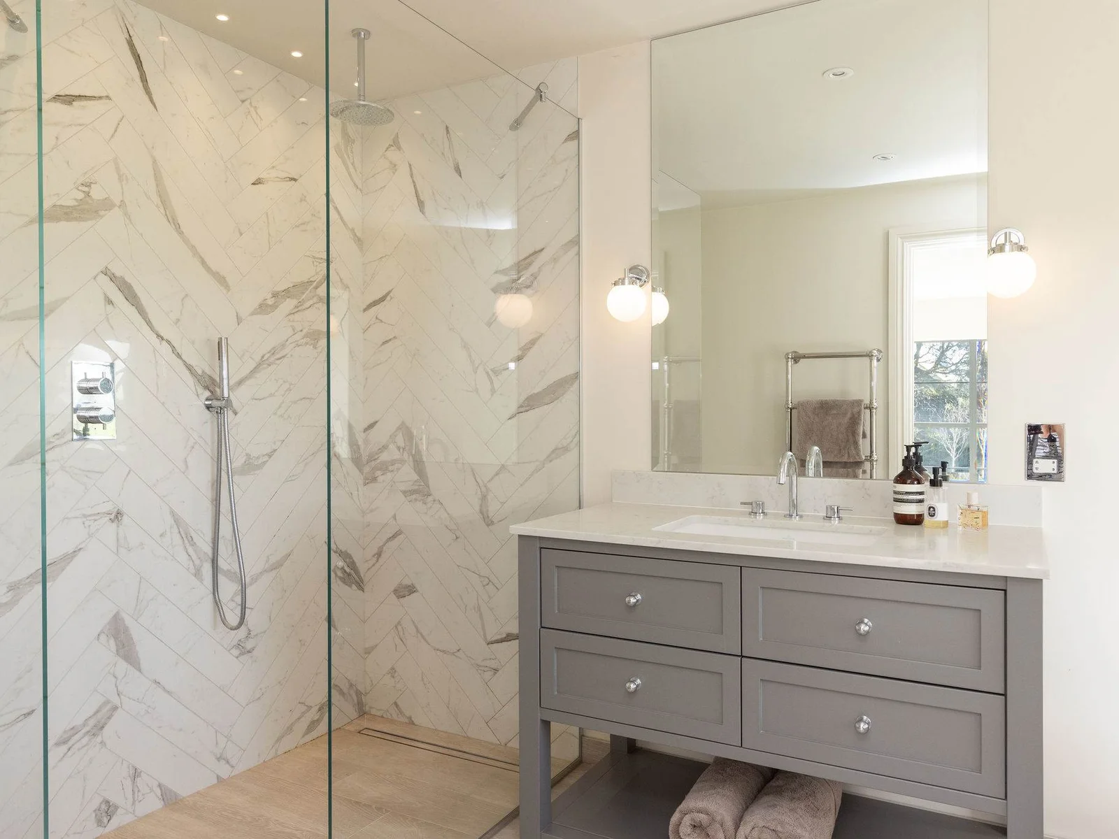 Contemporary ensuite with walk-in marble shower, stylish vanity, and modern fixtures throughout.