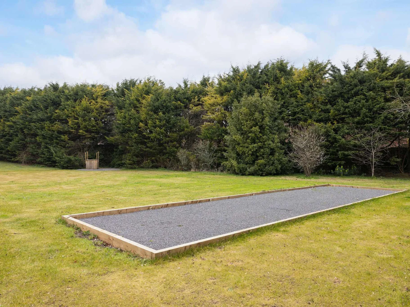 A newly built boules court set within a peaceful lawned area