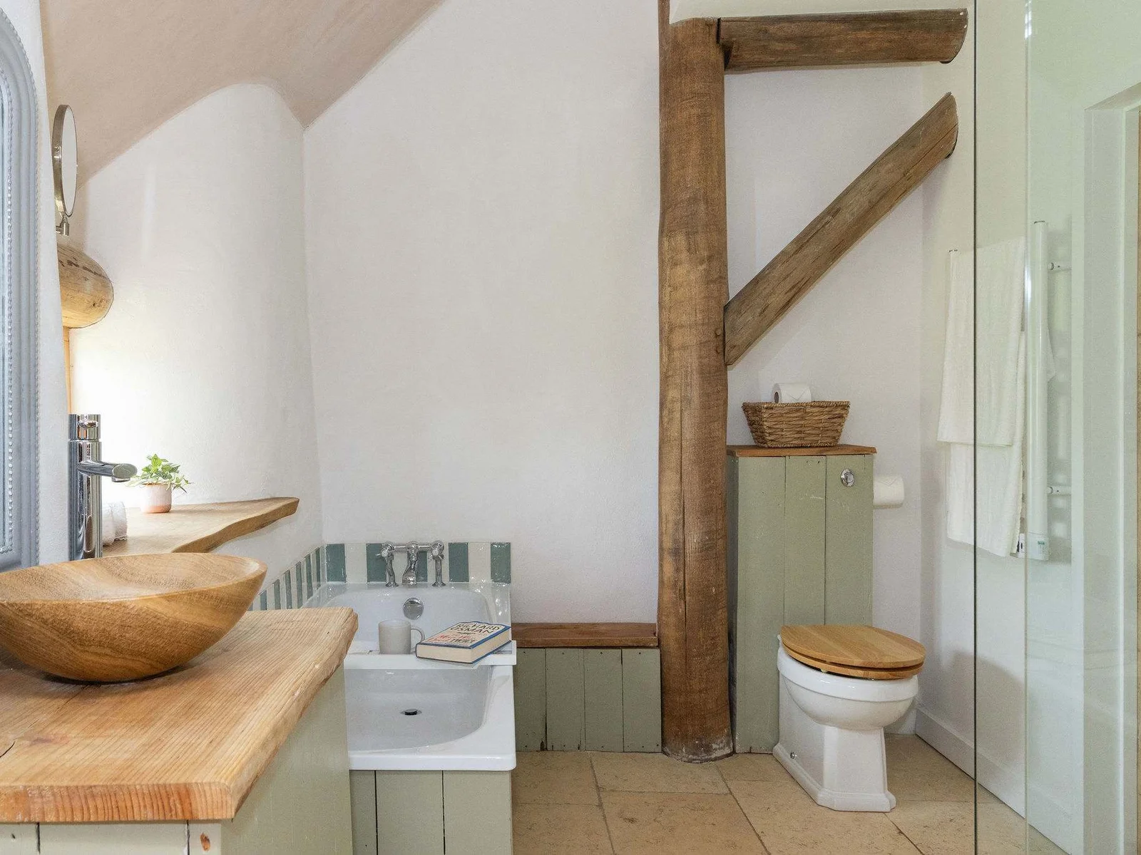 Handcrafted bathroom details with natural wood and sage green — rustic luxury at its finest.