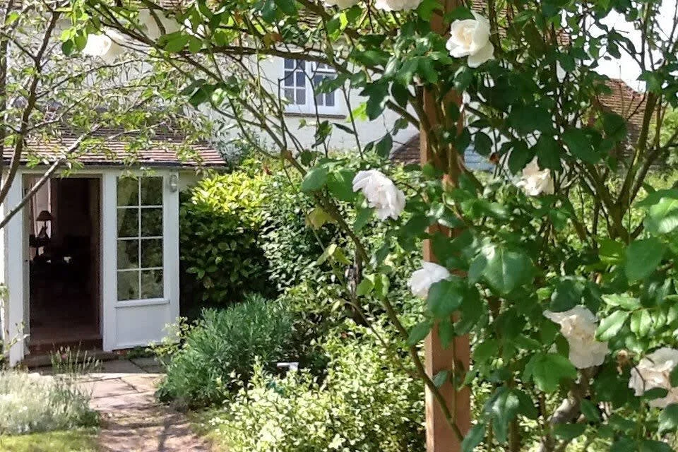 The cottage has a pretty garden, with field views and pretty plants.