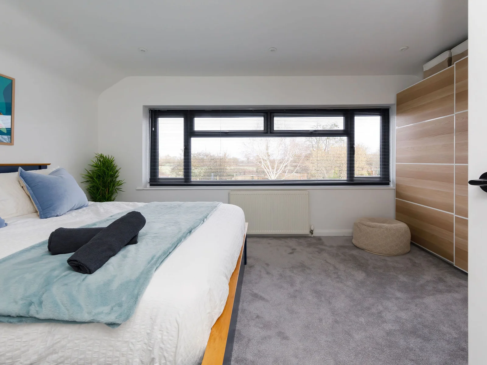 The master bedroom has a king size bed and large window to allow natural light to flood in.