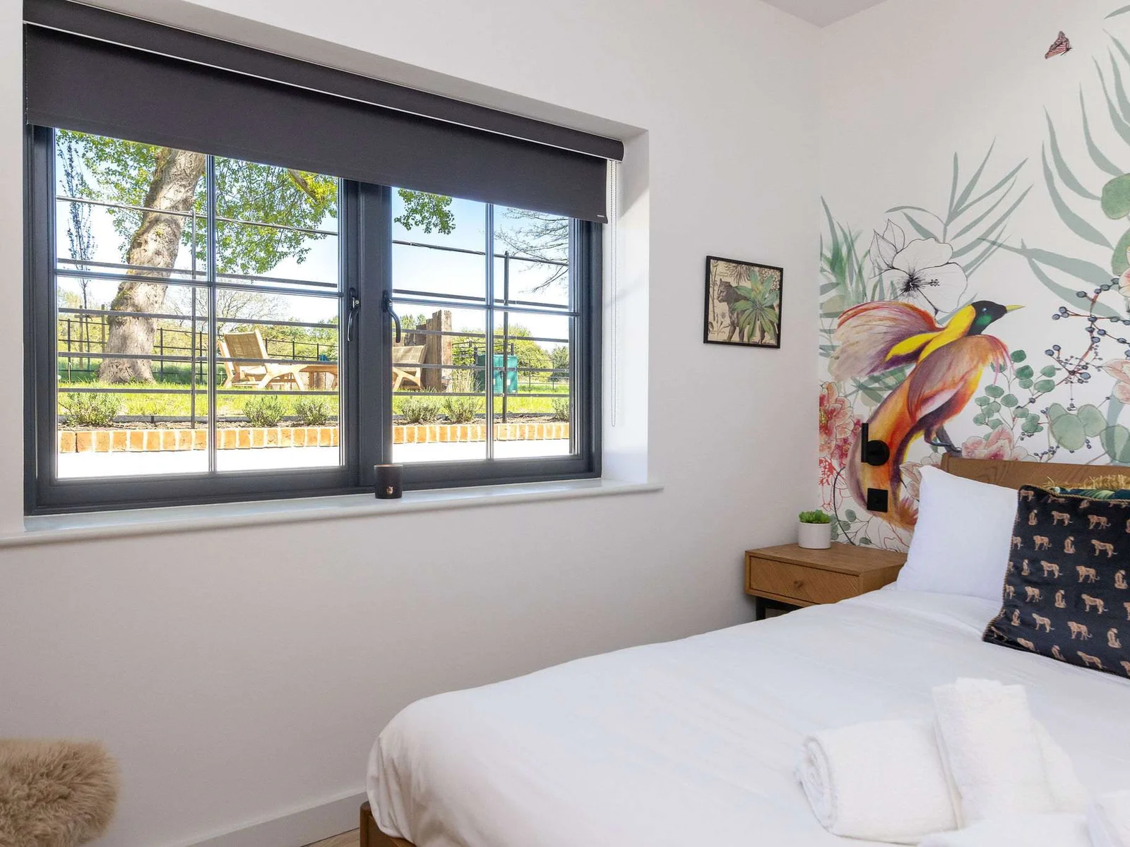 Wake beside leafy views, crisp linens, and cheerful wall art for a gentle Sussex escape.