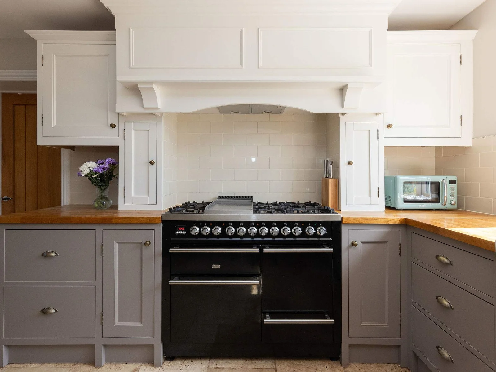 The heart of the kitchen — a traditional range-style cooker surrounded by classic cabinetry and warm wooden worktops, perfect for preparing everything from easy breakfasts to big family meals.