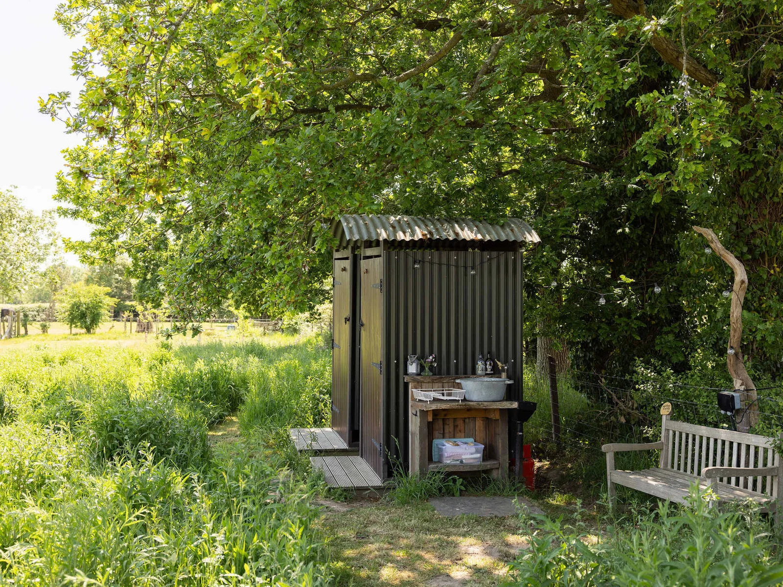 The shower and the toilet are just by the hut