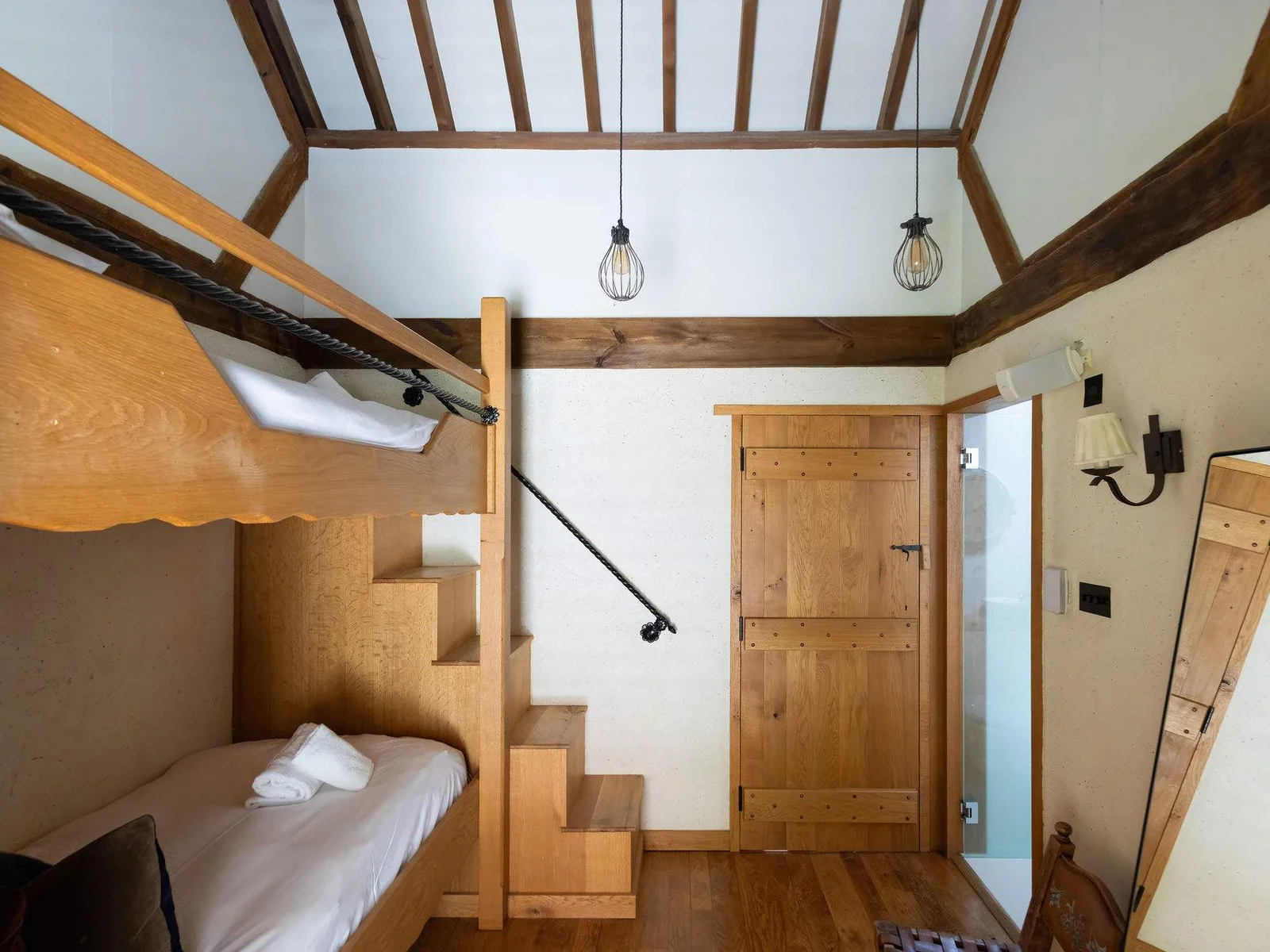 A cleverly designed bunk room, full of warm timber details and countryside charm.