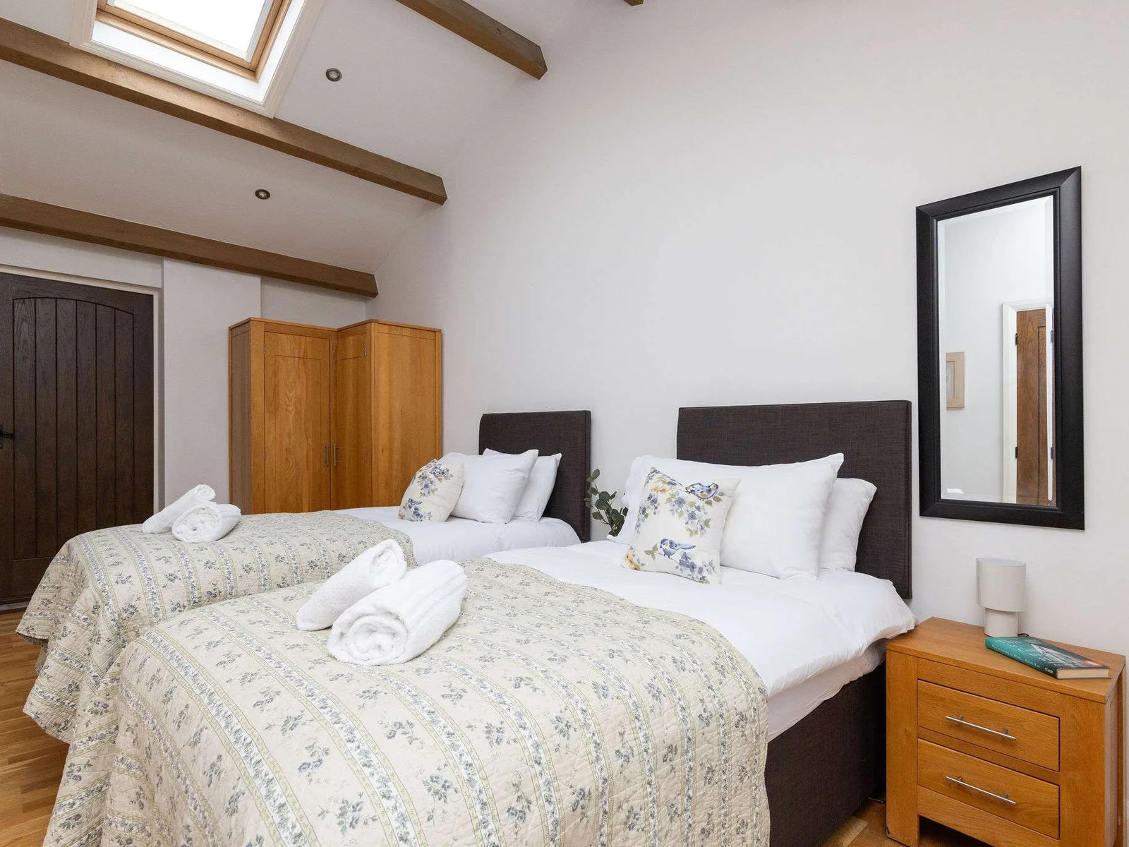 Clover room with floral bed throws and cottage charm.