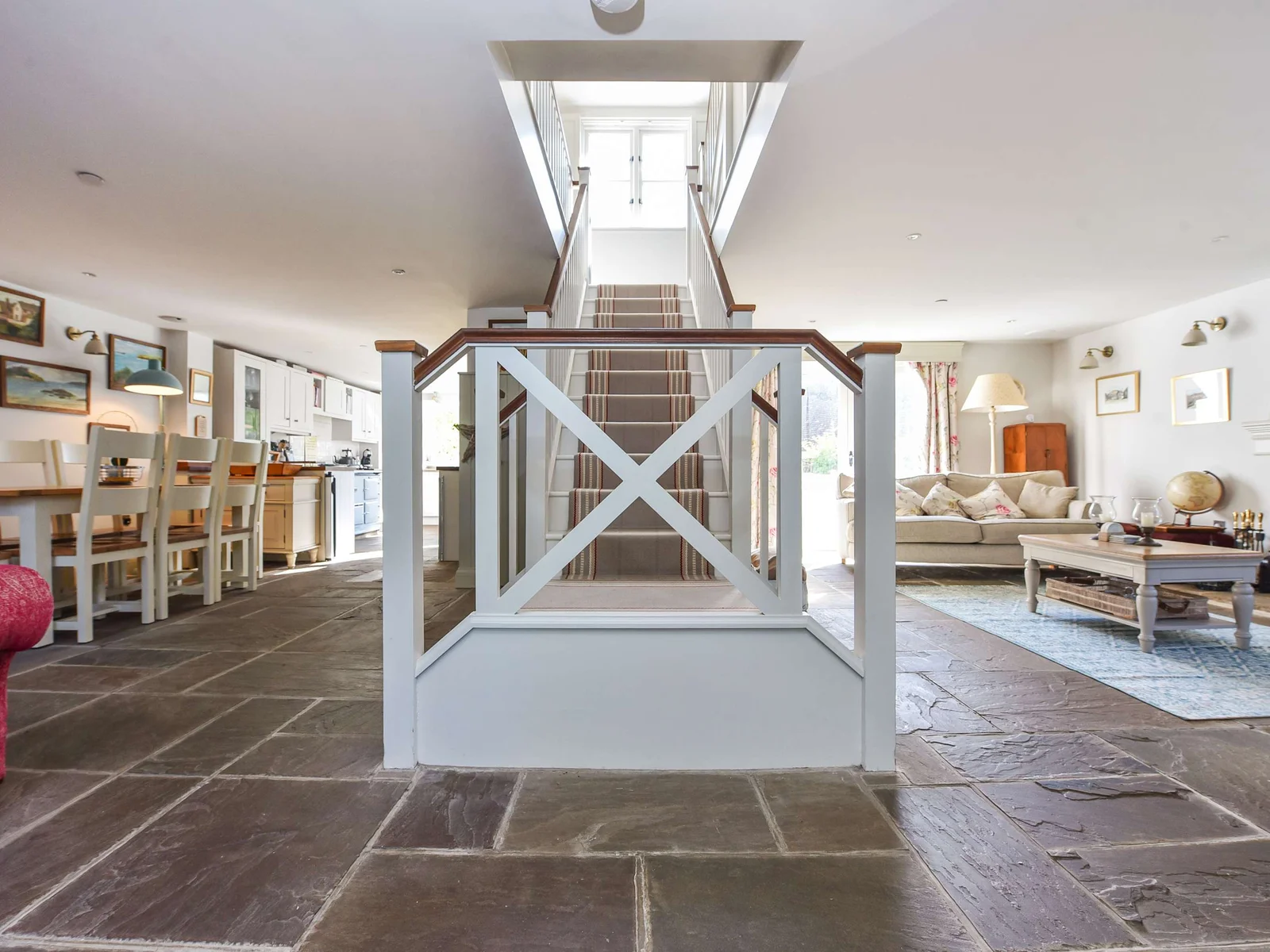Spacious open-plan layout with central staircase, dining area and cosy lounge