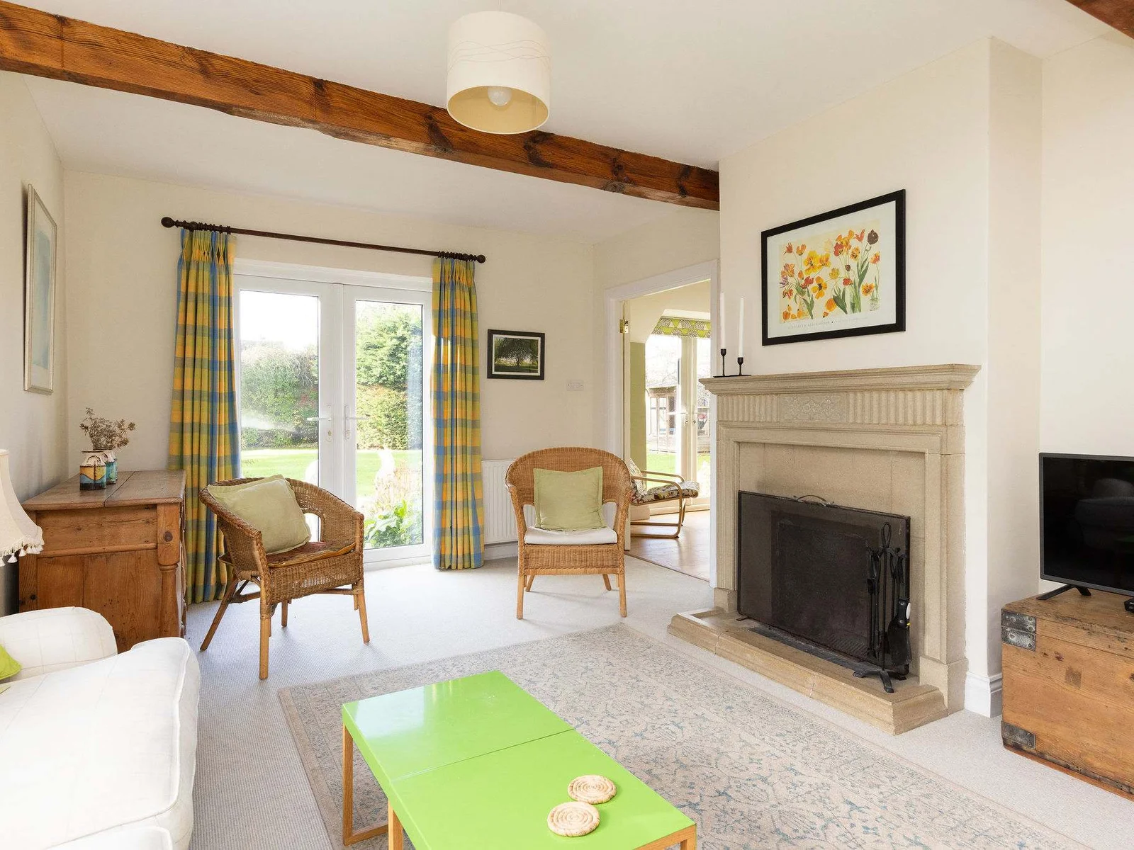Light and airy lounge with plenty of seating, tv and open fire