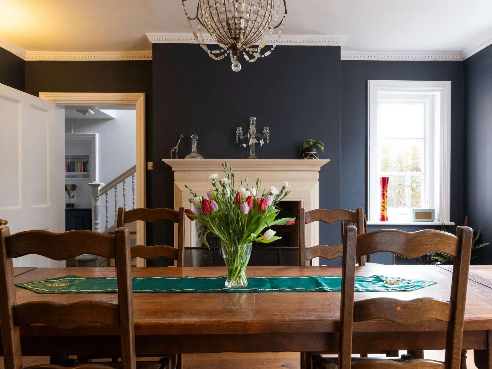 A grand dining table set under a classic chandelier, perfect for gatherings
