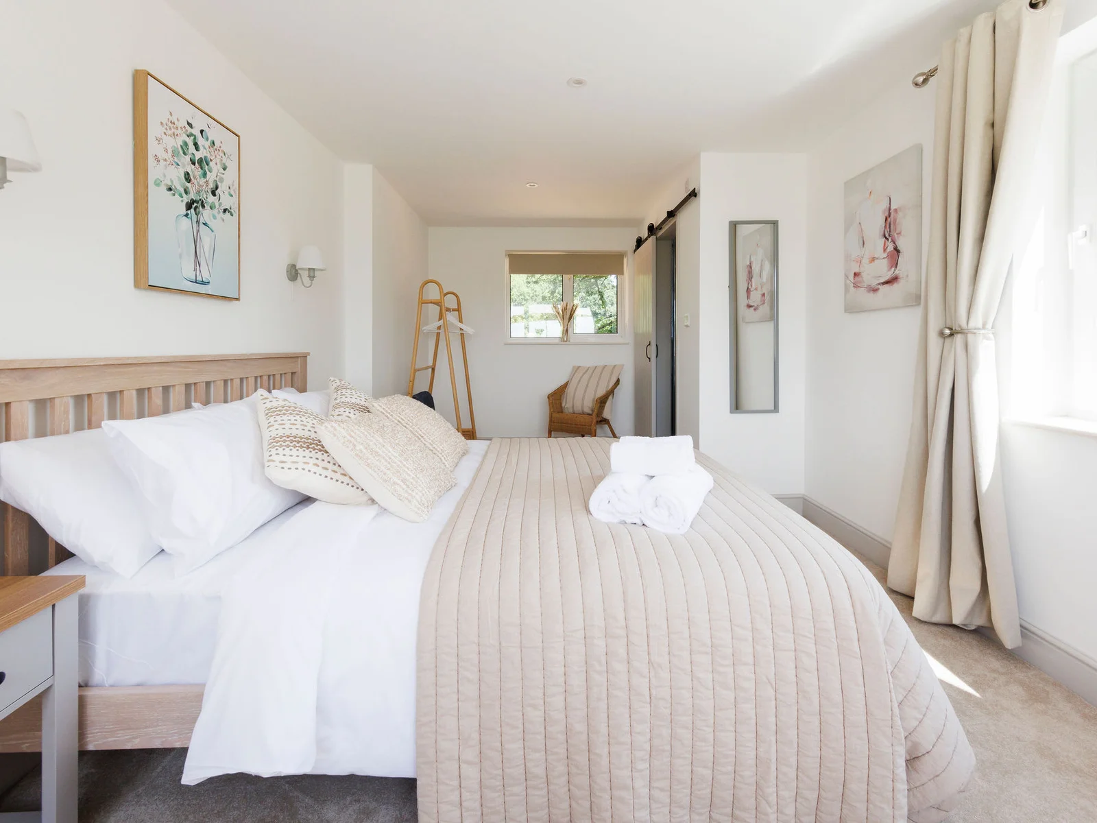 Elegant master bedroom with soft, inviting linens and rustic charm
