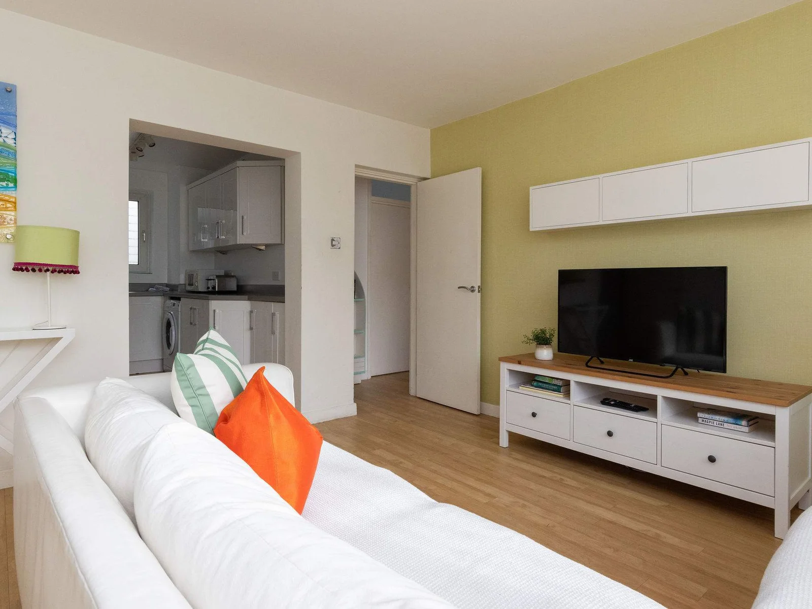 Inviting open-plan lounge with Smart TV and easy flow to the kitchen, perfect for socialising and unwinding.
