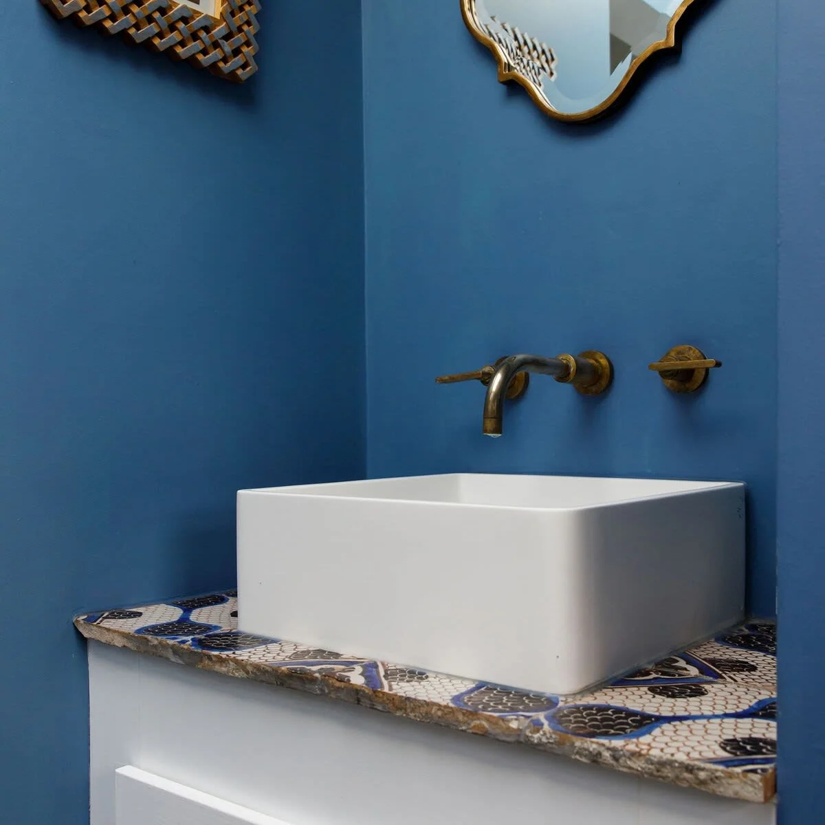 Patterned tiles and pretty cupboard door handles.