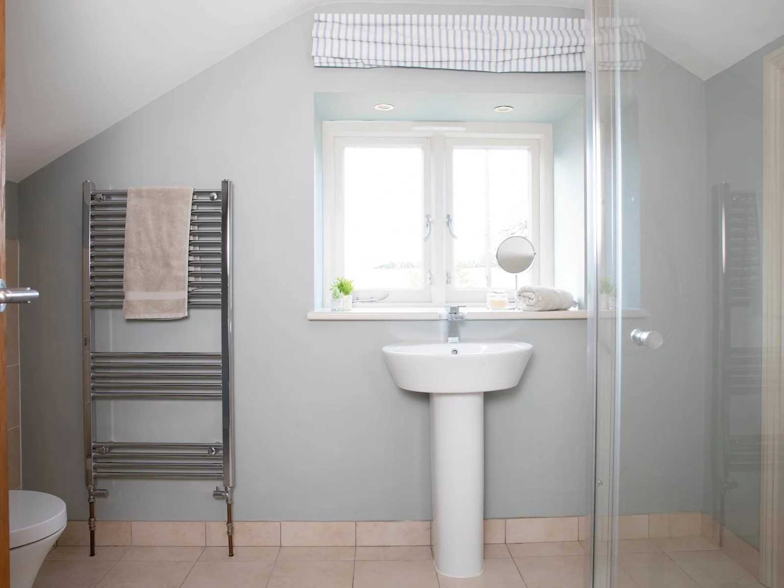 The en suite has a good size walk in shower, basin, toilet and heated towel rail