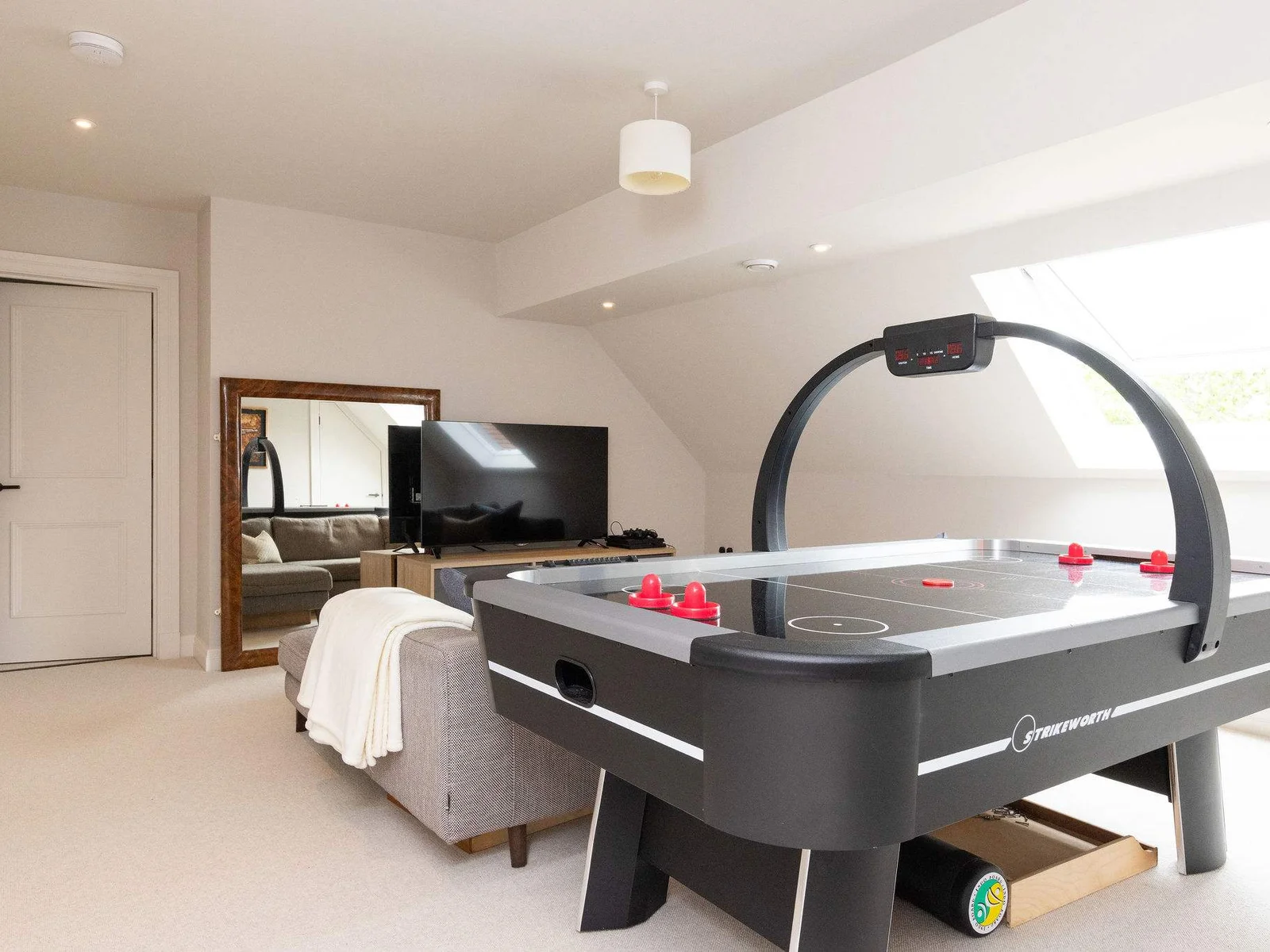 Spacious games room with air hockey, lounge area w Playstation