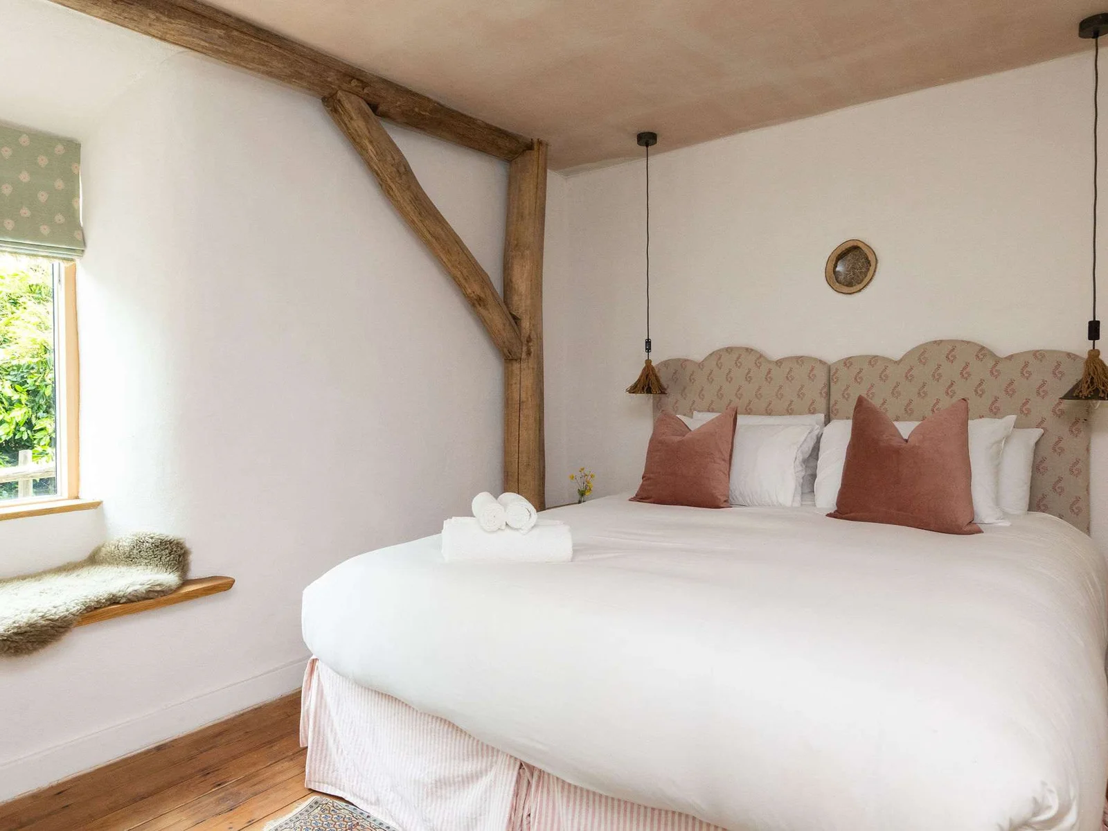 Crisp white linens, warm timber beams and countryside light — sleep in pure comfort.