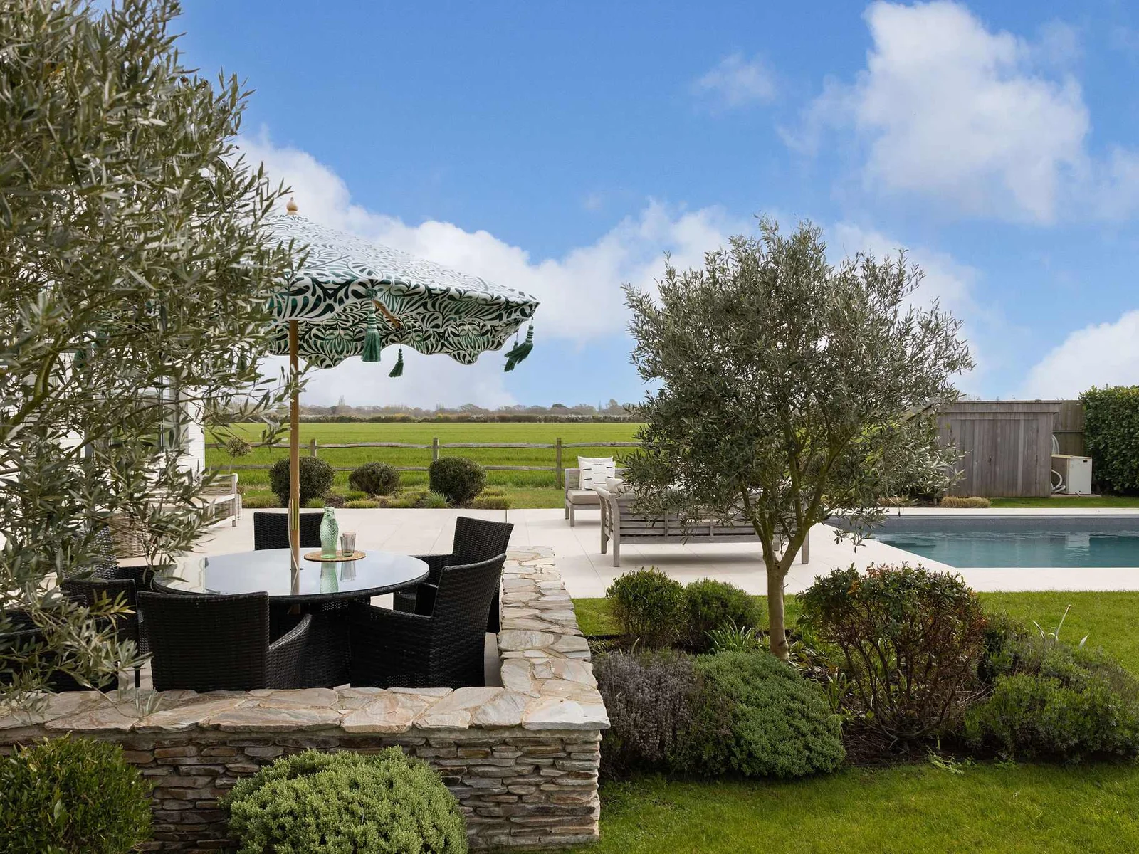 Al fresco dining among olive trees and landscaped gardens with the pool just steps away.
