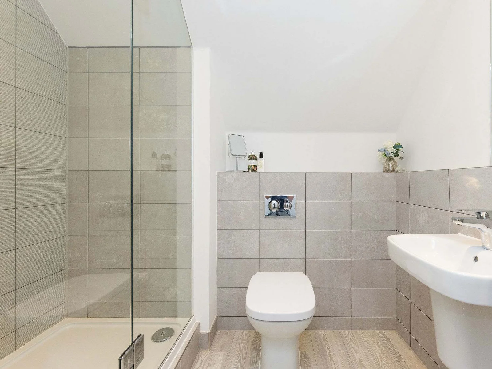 A modern bathroom featuring a spacious walk-in shower, perfect for freshening up.