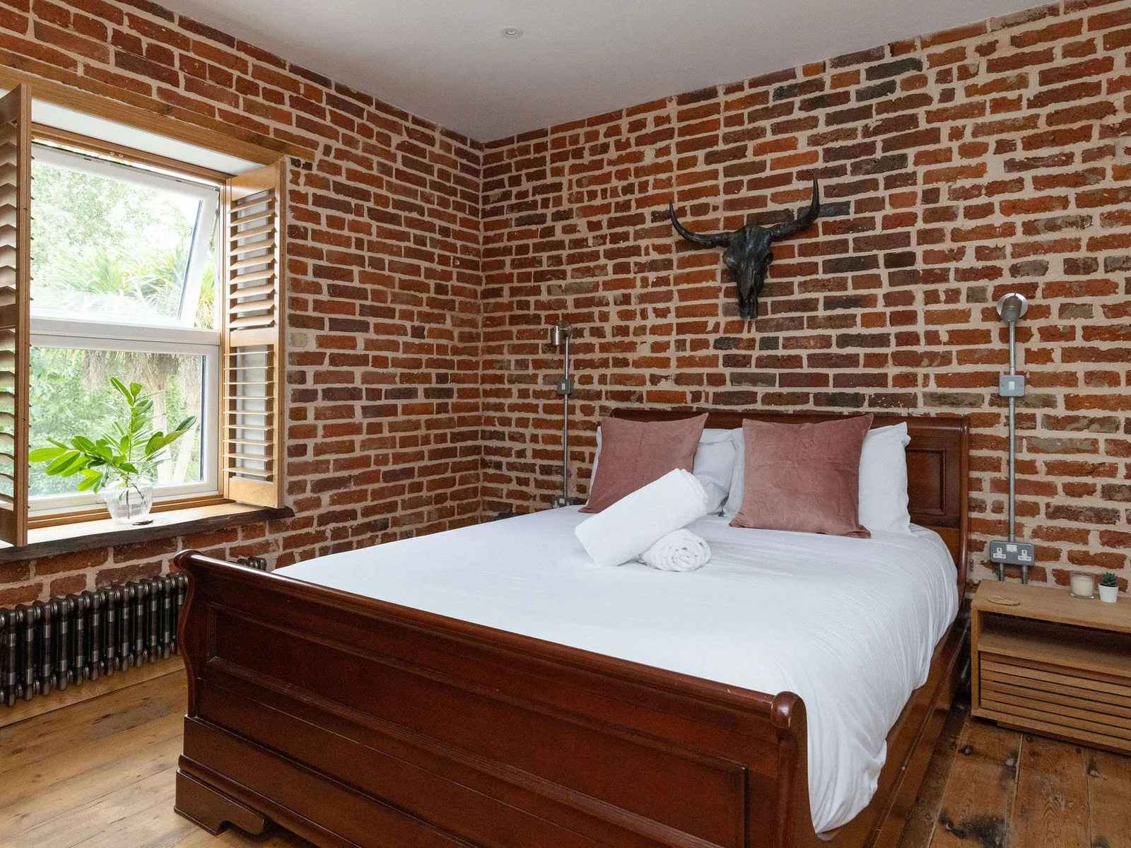 Bedroom 2- Brick walls are a running theme throughout the property!