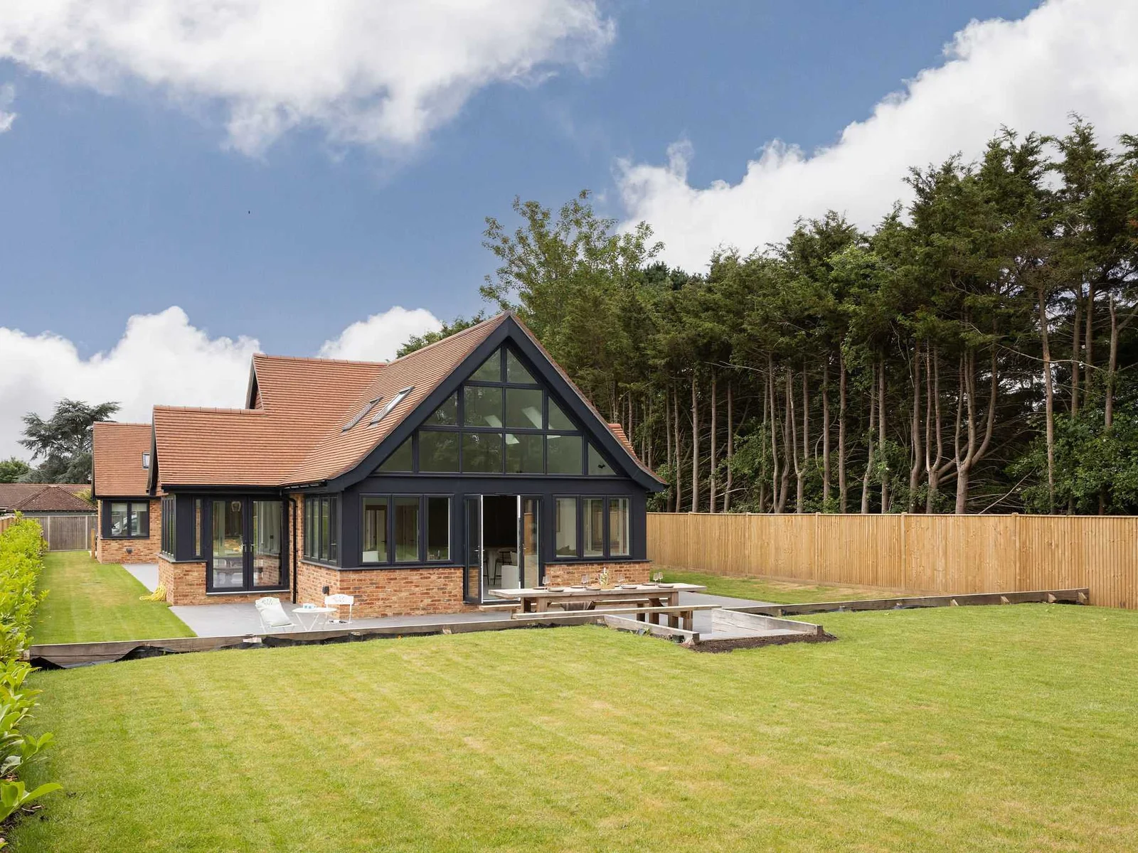 Peaceful rural home surrounded by greenery and open lawn
