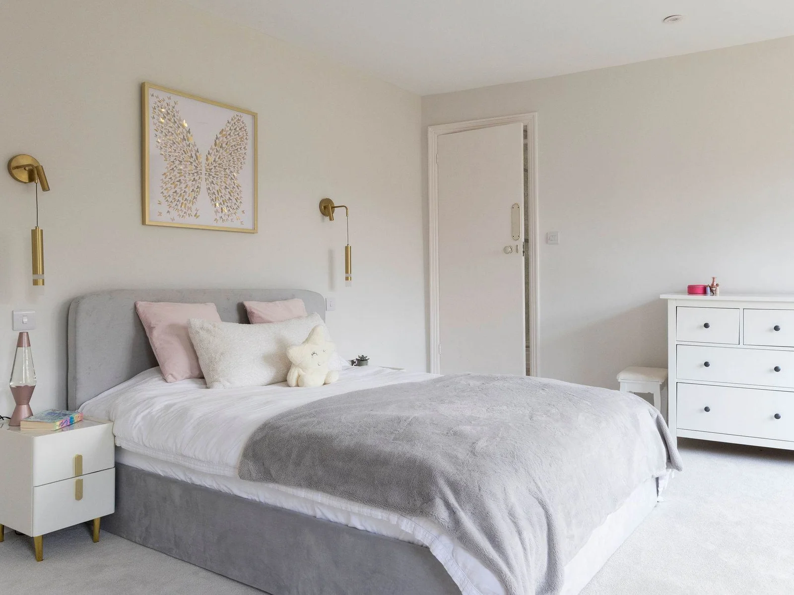A chic bedroom with a plush bed and soft lighting