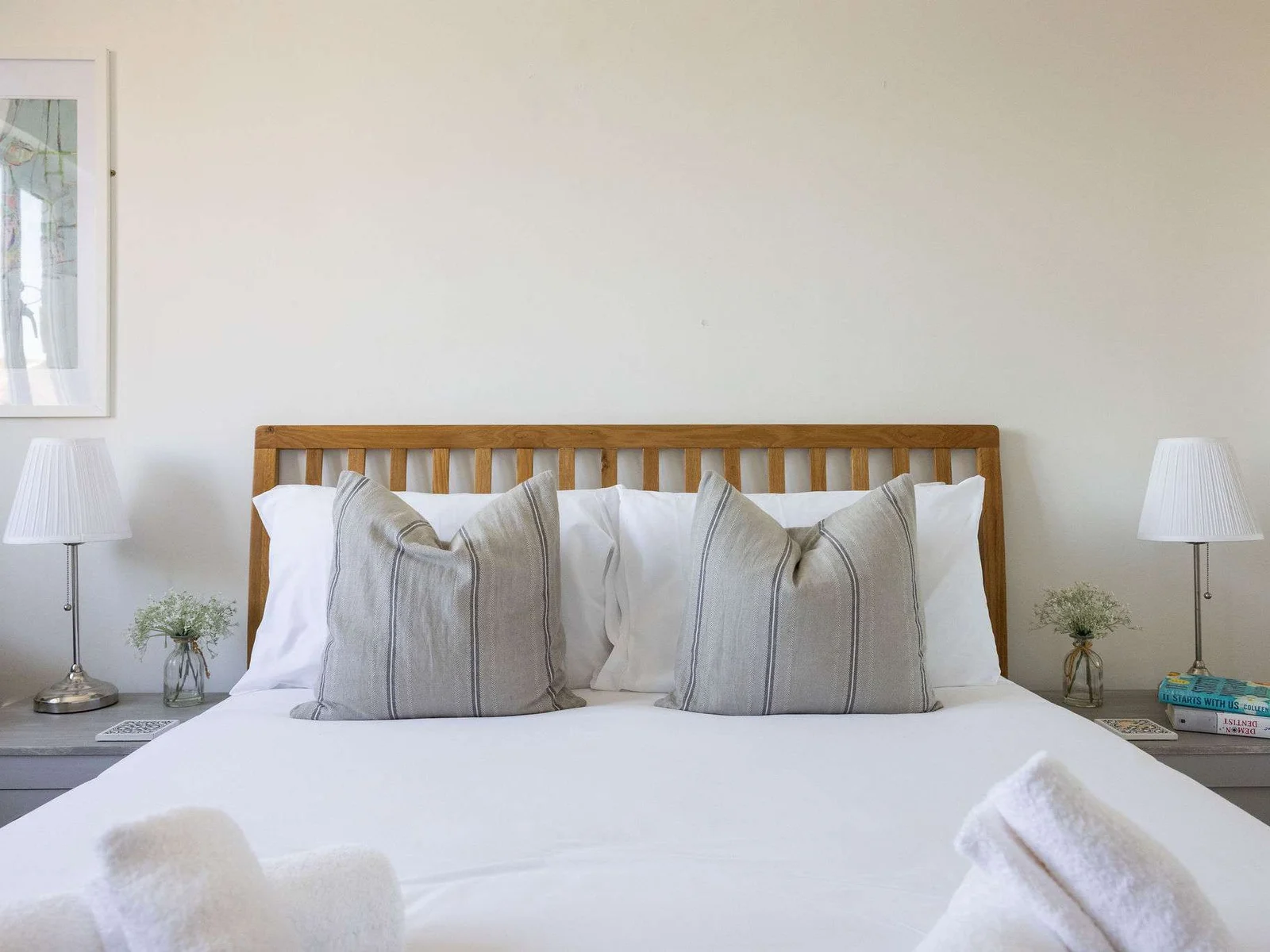 Peaceful king bedroom featuring crisp bedding and calming décor for a relaxing seaside stay.