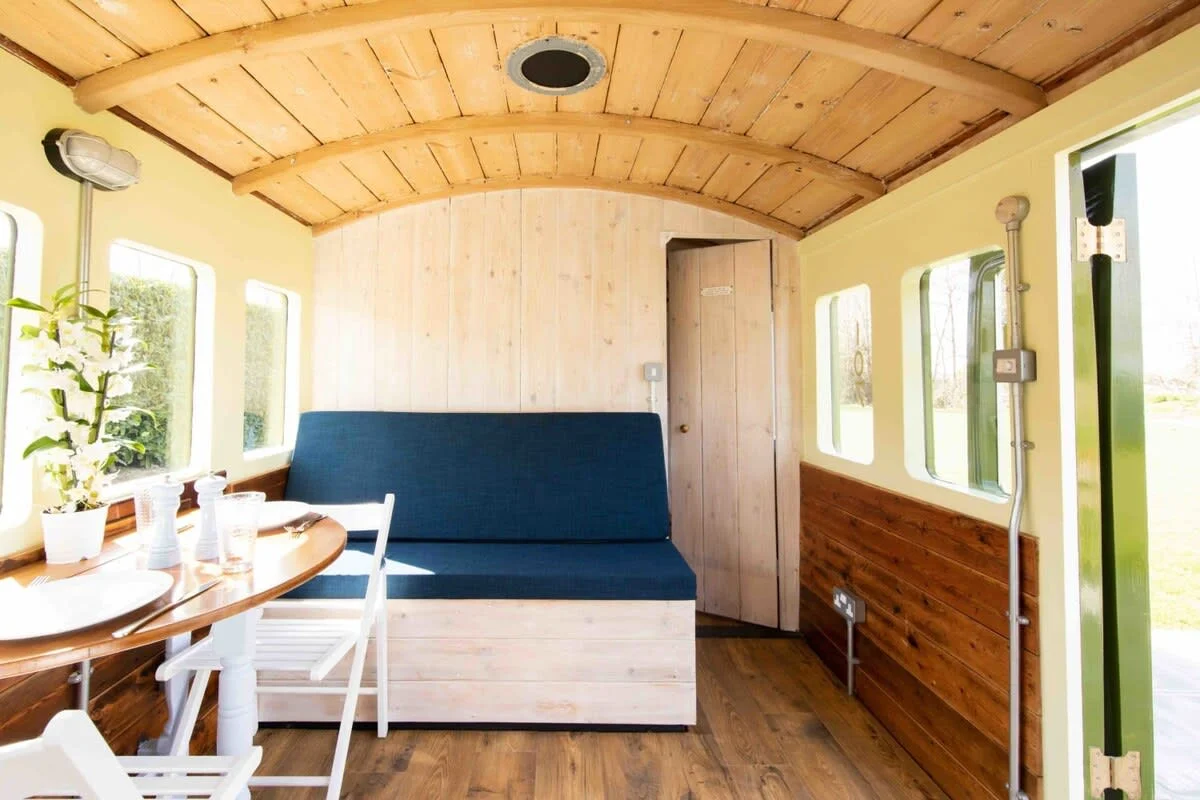 The lounge area has a dining table and clever seating area that transforms into bunk beds.