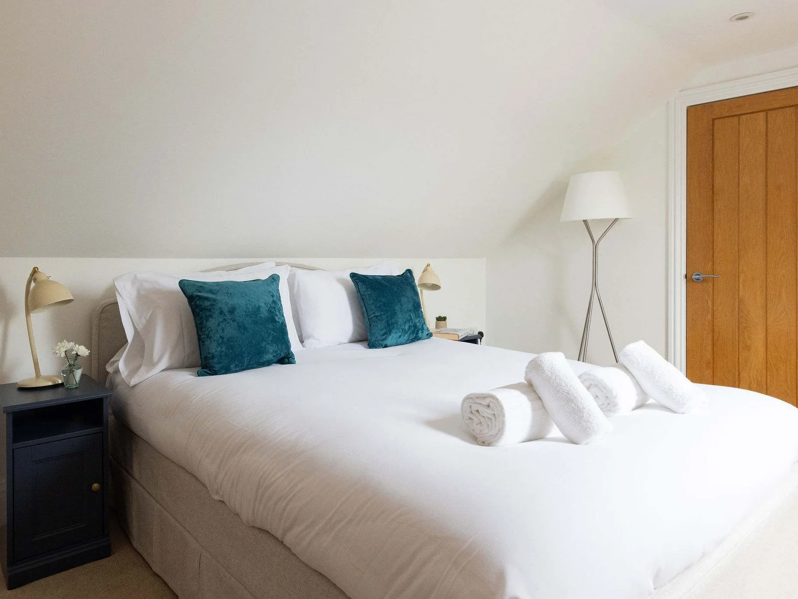This generous top-floor double comes with a large bed, bedside table and lamp, full-length floor lamp and plenty of floor space — a great room for guests wanting a little extra room to themselves.
