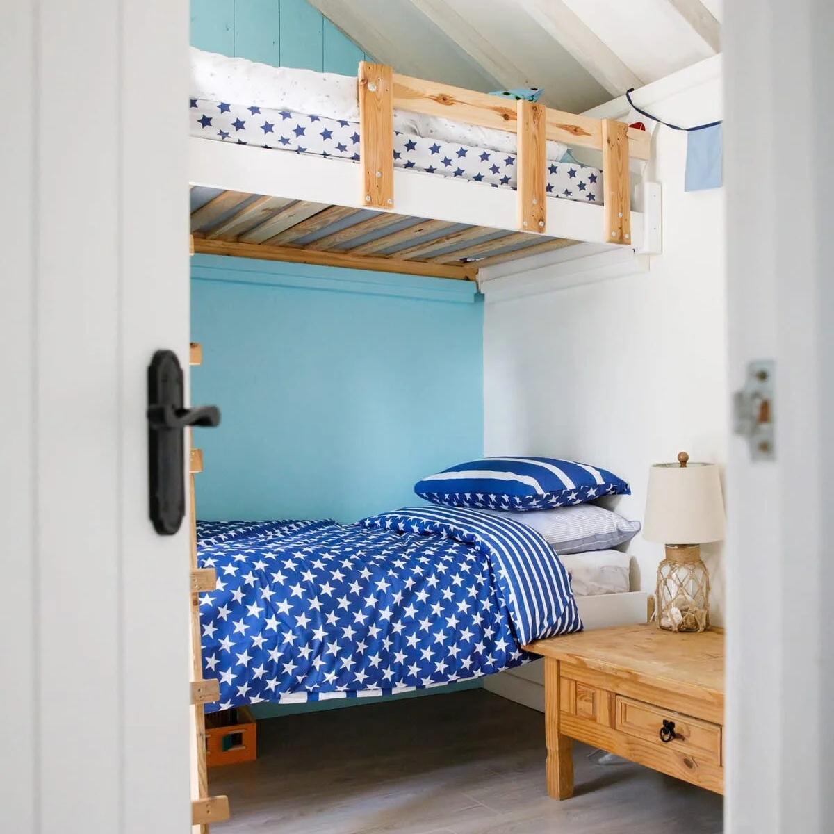 The second room is a bright and colourful bunk room.
