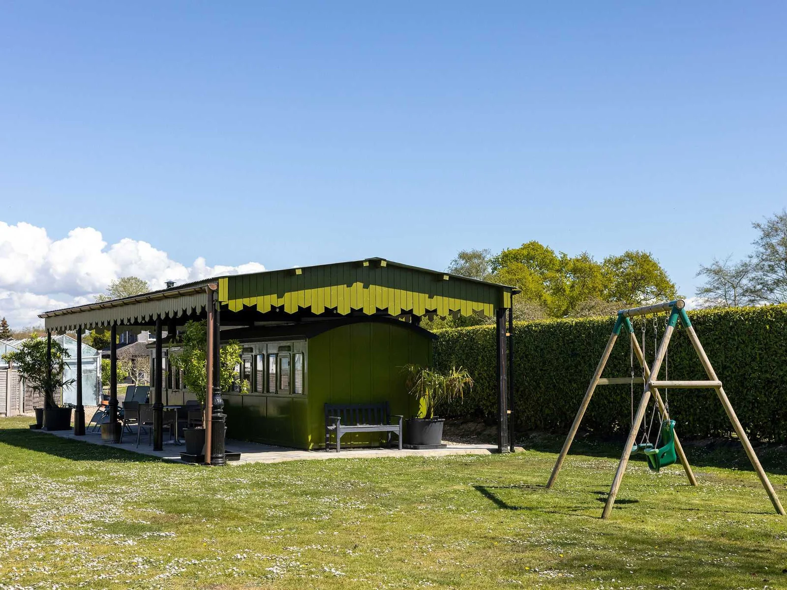 The carriage has a private outdoor space, with undercover patio, outdoor dining furniture, BBQ and swing set.