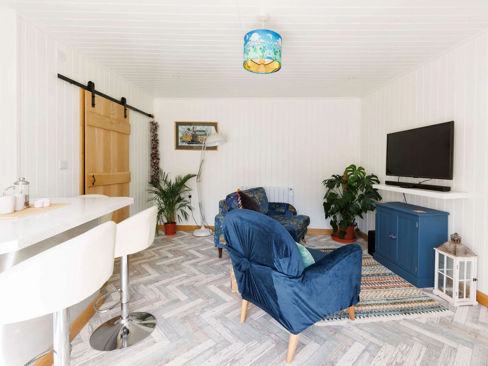 You will find a comfortable living area with smart TV, and well-equipped kitchen featuring a breakfast bar for casual dining.