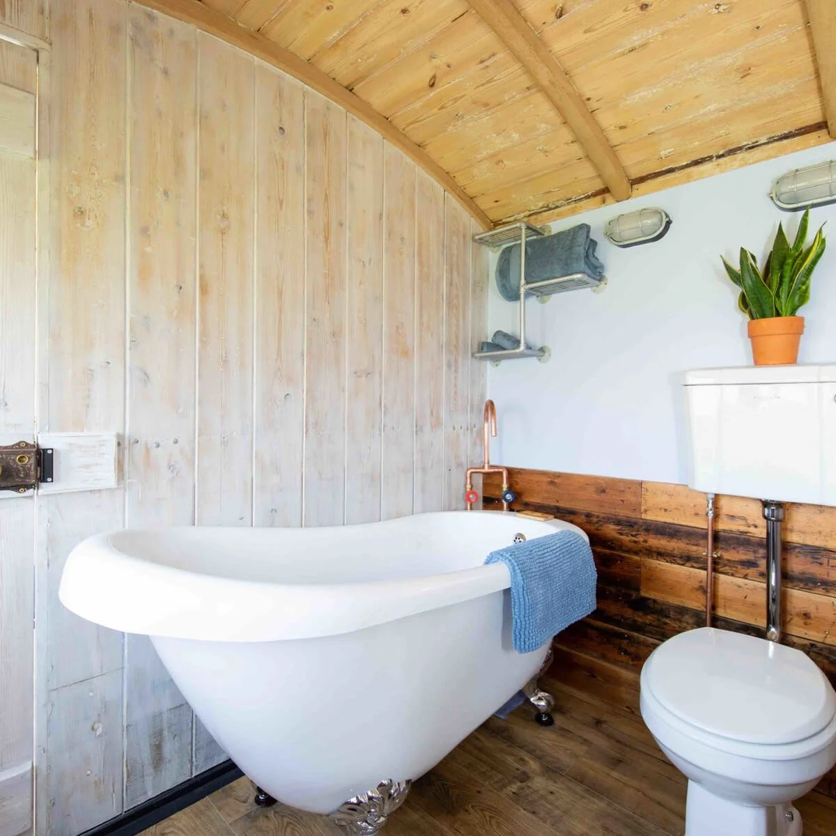 The spacious, cladded bathroom with free standing bath.