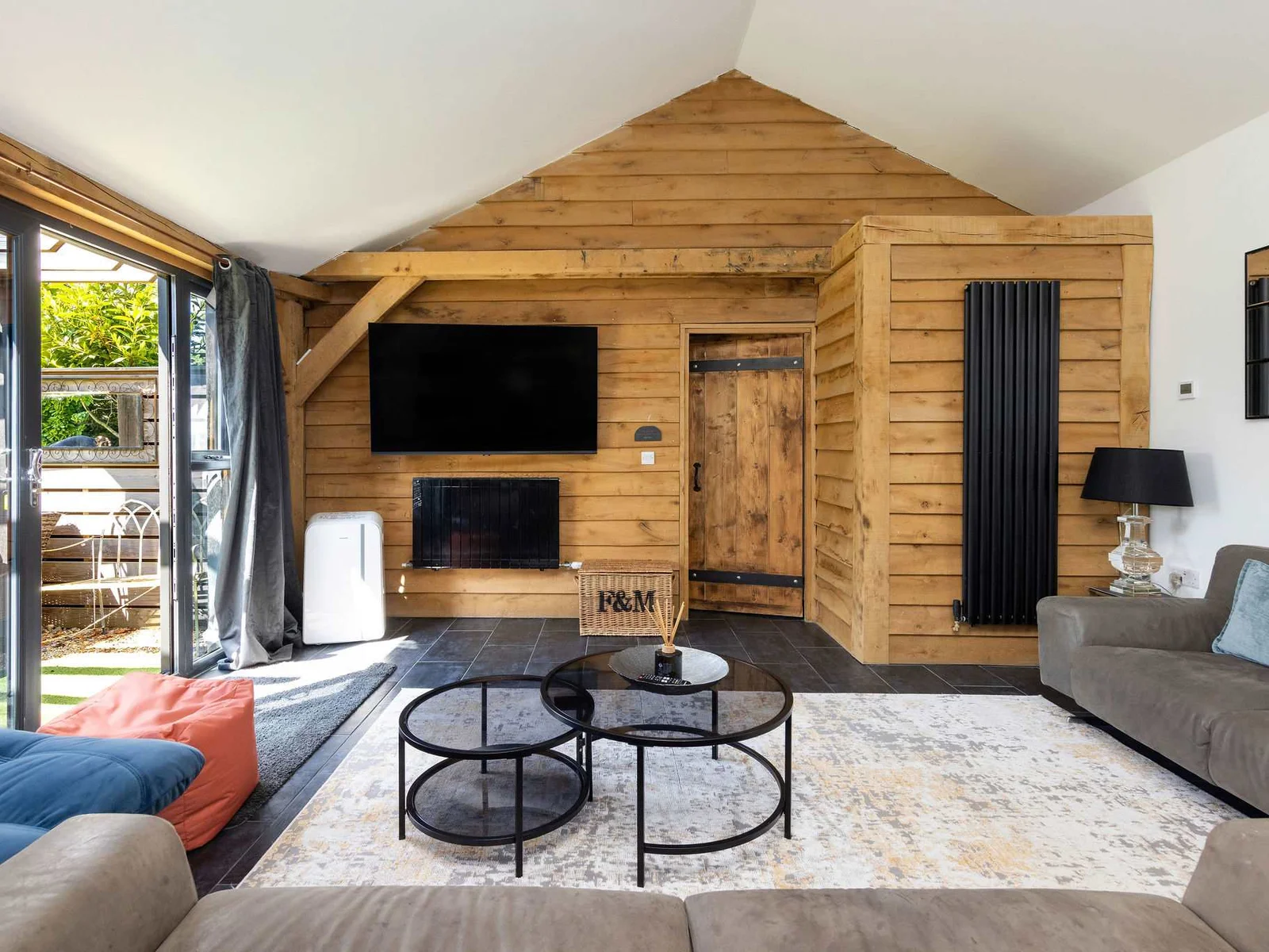 Cozy up in this stylish living area featuring rustic wood and courtyard access.