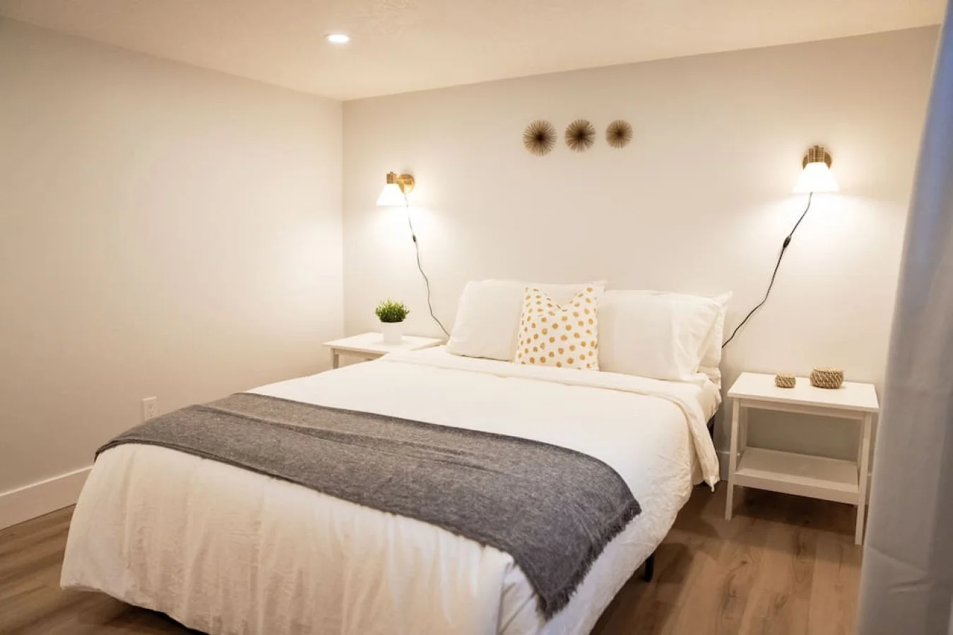 You feel enveloped in comfort as you relax on the queen bed, surrounded by a room designed for tranquility.
